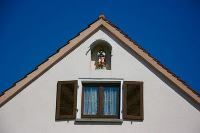 Low angle view of building against clear blue sky