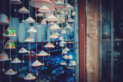 Illuminated lanterns hanging in market stall for sale