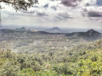 Scenic view of mountains against cloudy sky