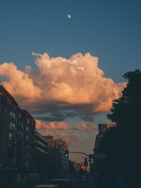 Low angle view of buildings against sky at sunset