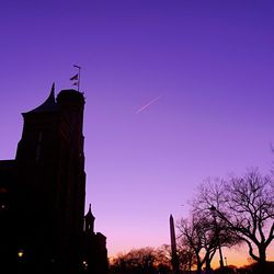 Silhouette built structure against sky at sunset