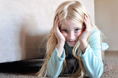 Portrait of cute girl relaxing on floor at home