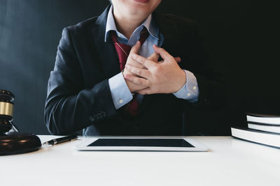 Midsection of man using smart phone