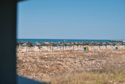 Scenic view of beach against clear blue sky