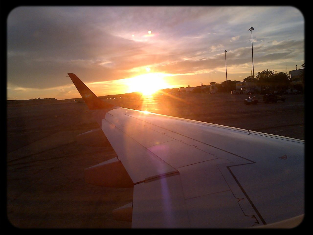 transfer print, sun, transportation, sunset, sky, auto post production filter, sunlight, mode of transport, cloud - sky, sunbeam, lens flare, airplane, travel, air vehicle, cloud, aircraft wing, outdoors, car, no people, cloudy