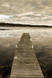 Pier over lake against sky