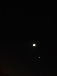 Low angle view of moon against sky at night