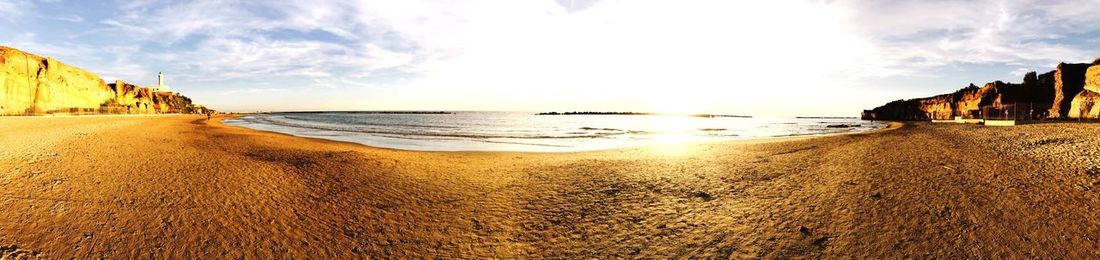 Panoramic view of beach against sky during sunset