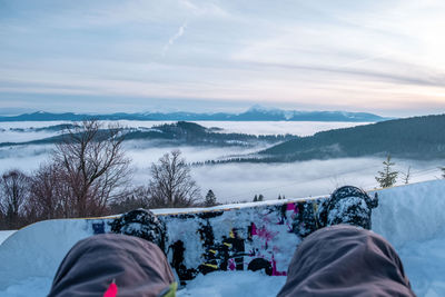 Low section of person skiing on snow covered landscape