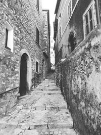 Low angle view of narrow alley amidst old buildings