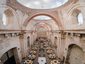 High angle view of tables and chairs arranged in historic restaurant