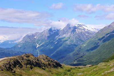 Scenic view of mountains against cloudy sky