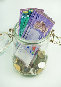 Close-up of coins on table against white background