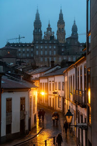 Despite the cloudy night, the illuminated cathedral of santiago de compostela in spain