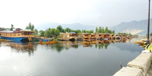 Boats in lake against sky