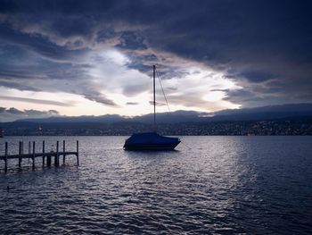 Sailboats in sea against sky during sunset