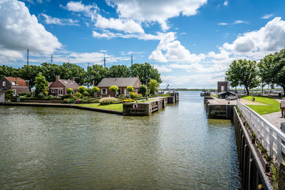 Canal against cloudy sky