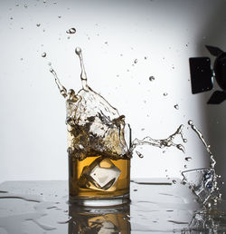 Close-up of water splashing against white background