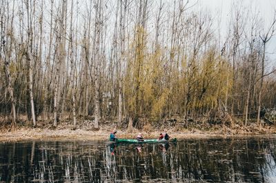 People by lake in forest