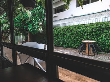 Chairs and table by window in yard of house