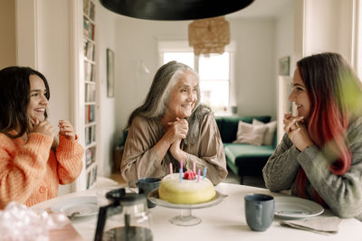 Happy multi generational family celebrating birthday together at home