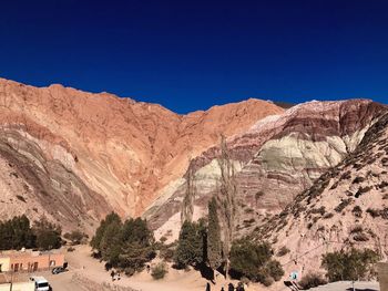 Scenic view of mountains against clear blue sky
