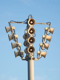 Low angle view of megaphones against clear sky