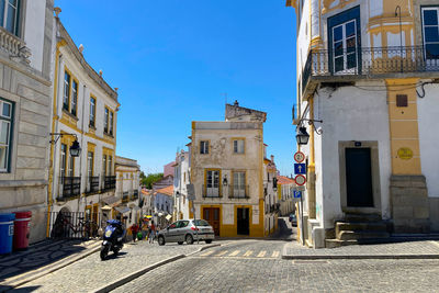 Street amidst buildings in city against sky