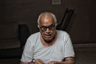 Portrait of man sitting at home