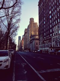 City street and buildings against sky