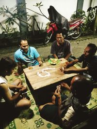 People sitting at market stall