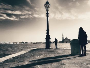 Silhouette of people on sea