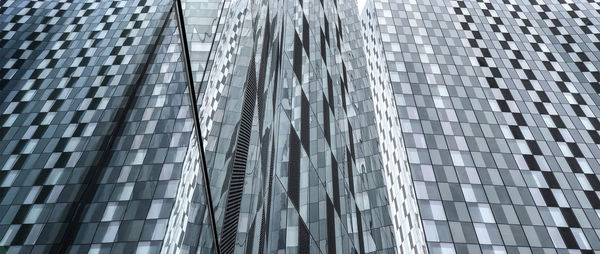 Low angle view of modern glass building in city