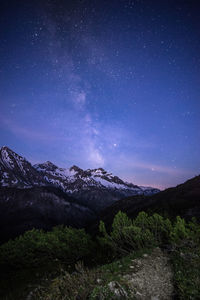 Scenic view of mountains against sky at night