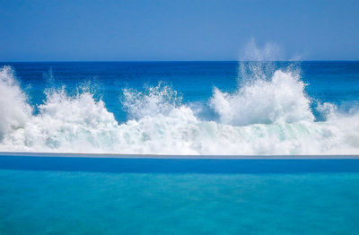 Scenic view of blue sea against clear sky