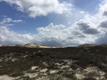 Scenic view of landscape against cloudy sky