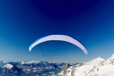 Scenic view of snowcapped mountains against blue sky