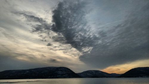 Scenic view of mountains against cloudy sky