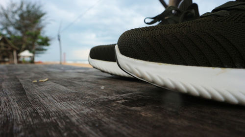 Close-up of shoes on wooden table