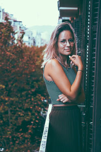 Portrait of young woman standing outdoors