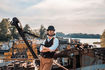 Portrait of young man standing against sky