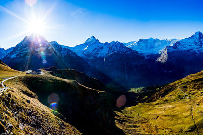 Scenic view of snowcapped mountain against blue sky