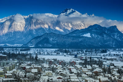 High angle view of snowcapped mountains against sky