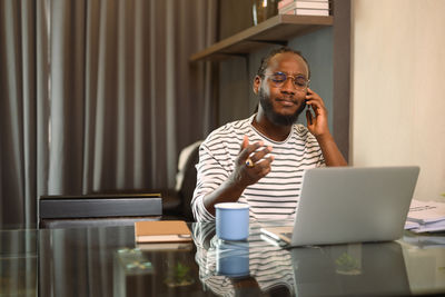 Young man using laptop at home