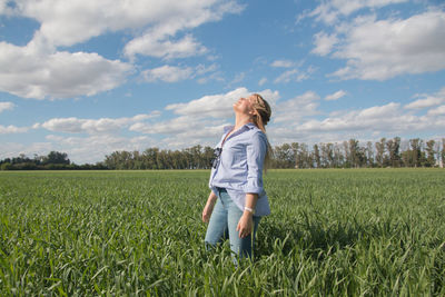 Full length of woman standing on field