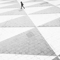 Shadow of person on tiled floor