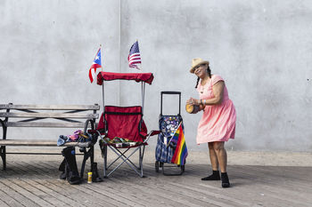 FULL LENGTH OF MAN HOLDING UMBRELLA STANDING ON FLOOR
