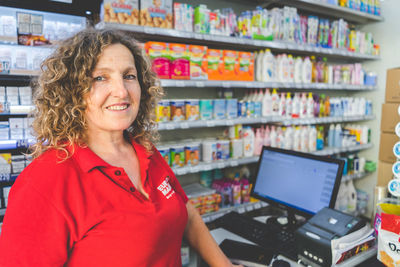 Portrait of smiling saleswoman in store