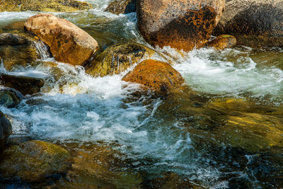 Water flowing through rocks in sea