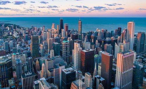 Aerial view of modern buildings against cloudy sky